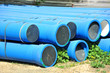 Stacked blue PVC pipe on construction site