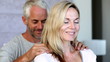 Man giving partner a shoulder rub