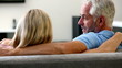Mature couple watching television