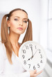 woman holding big clock