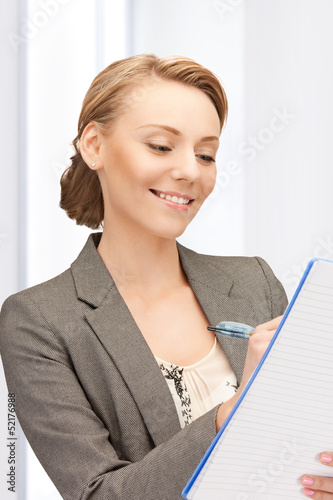 Photo: happy woman with big notepad happy woman with big notepad