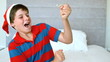 Happy boy using party popper in the bedroom