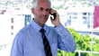 Video: Businessman answering his phone and looking impressed Businessman answering his phone and looking impressed