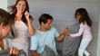 Smiling family having a pillow fight