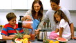 Video: Woman with family pouring fruit cocktail from a blender Woman with family pouring fruit cocktail from a blender