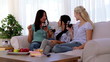 Laughing friends having fun while drinking red wine