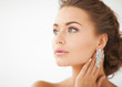 woman wearing shiny diamond earrings