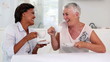 Two mature women gossiping during afternoon tea
