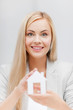 woman holding paper house