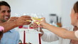 Family toasting at christmas at the dinner table at home