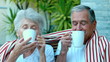 Retired couple enjoying coffee outside in slow motion