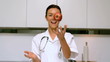 Video: Home nurse throwing and catching apple and smiling in kitchen Home nurse throwing and catching apple and smiling in kitchen