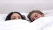 Couple cozied up under the covers
