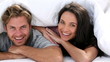 Attractive couple cozy under the covers