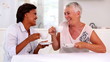 Two mature women gossiping during afternoon tea