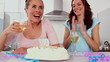 Woman blowing out candle on her birthday cake