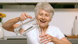 Retired woman pouring glass of water