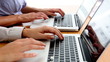 Business people typing on their laptops