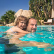 Child and father in swimming pool