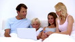 Cute family using laptop to shop online together