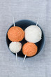 Orange and white balls of yarn and knitting needles