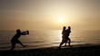Drunk guy with bottle of champagne running after loving couple