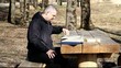 Man reading a book outdoors