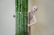 Wooden man standing at home and looking out of the tree. People