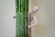 Wooden man standing at home and looking out of the tree. People