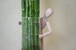 Wooden man standing at home and looking out of the tree. People