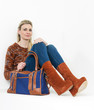 sitting woman wearing fashionable platform brown shoes with a ha