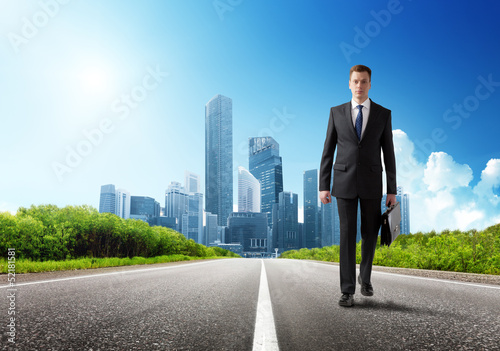 Photo: business man walking on the road business man walking on the road