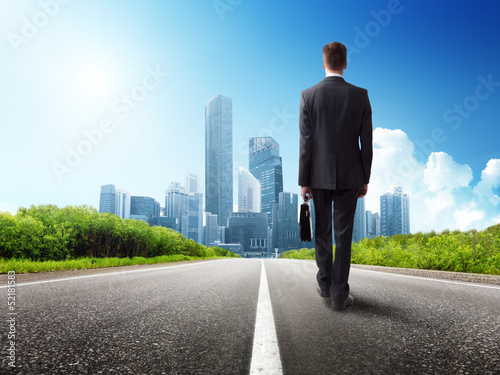 Photo: business man walking on the road business man walking on the road