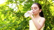 Teenage girl drinking water out of a plastic bottle