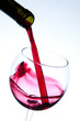 Red wine pouring into wine glass