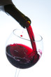 Red wine pouring into wine glass