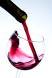 Red wine pouring into wine glass