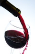 Red wine pouring into wine glass