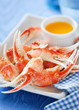 Boiled crab claws with orange sauce, selective focus