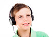 Photo: Portrait of smiling young boy listening to music on headphones a Portrait of smiling young boy listening to music on headphones a