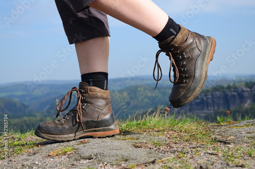 Photo: Hiking woman in trekking boots Hiking woman in trekking boots