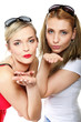 Two young women blowing kisses to the camera