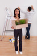 Photo: Couple Carrying Boxes In House Couple Carrying Boxes In House