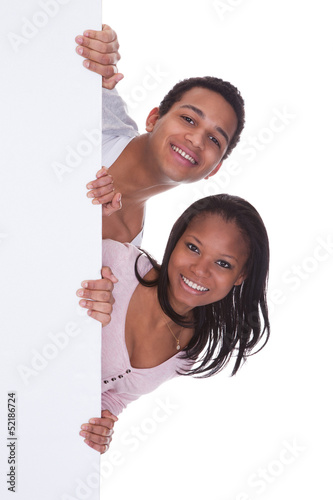 Photo: Young Couple Holding Placard Young Couple Holding Placard