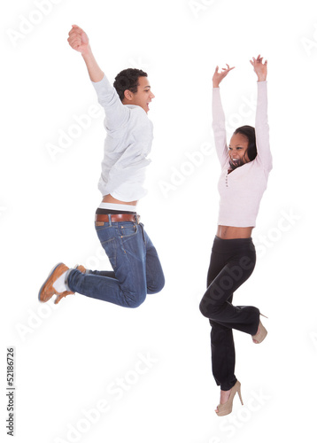 Photo: Young Couple Jumping In The Air Young Couple Jumping In The Air