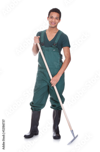 Photo: Happy young gardener in dungarees Happy young gardener in dungarees