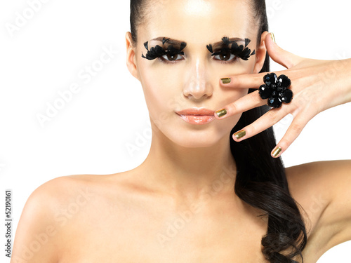 Photo: Woman with golden nails and style makeup Woman with golden nails and style makeup