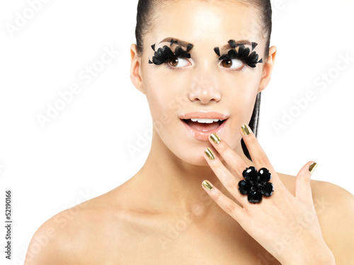 Photo: Woman with golden nails and style makeup Woman with golden nails and style makeup