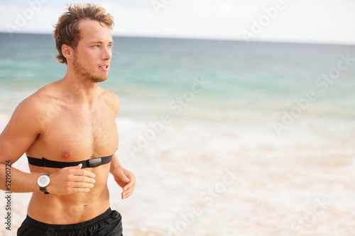 Photo: Runner man running with heart rate monitor Runner man running with heart rate monitor