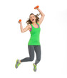Happy fitness young woman with dumbbells jumping